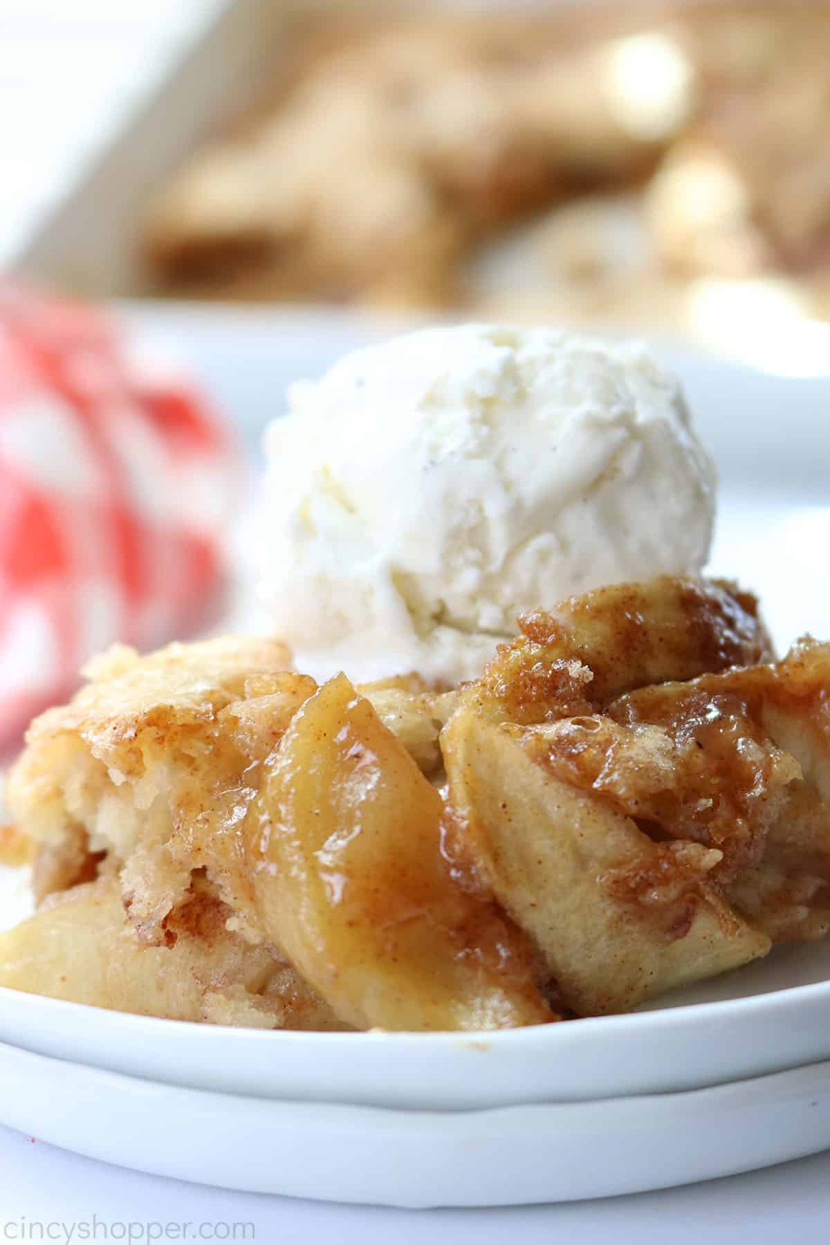 Apple Cobbler with a scoop of ice cream on a white plate.