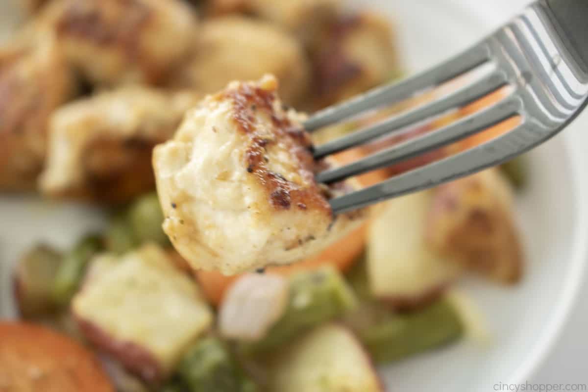 Pan fried chicken bite on a fork.