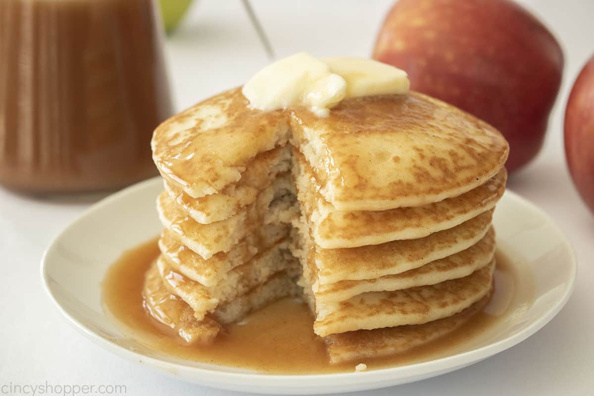 Stack of Pancakes with apple pancake syrup and butter on top.