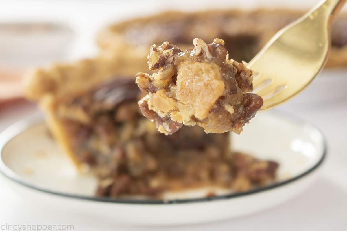 Closeup of pecan pie on a fork.