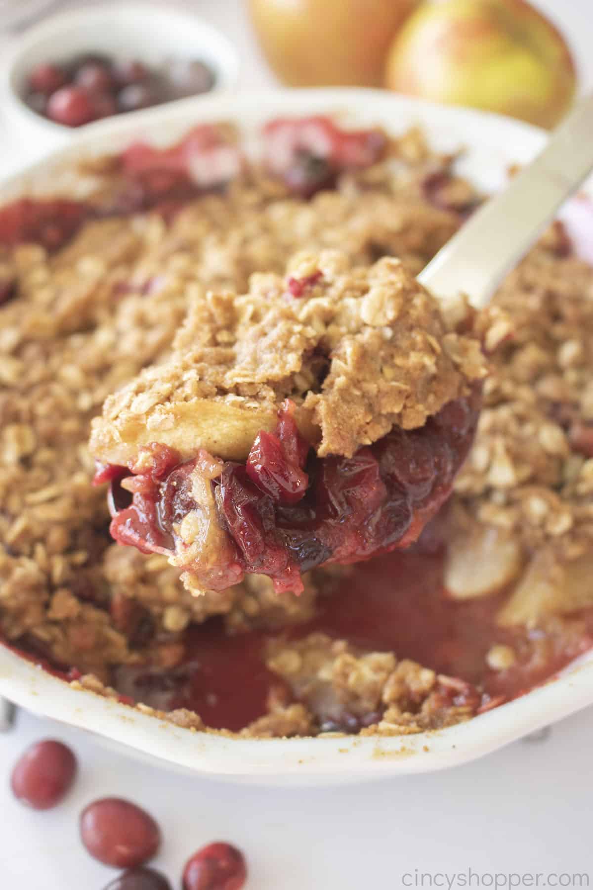 Cranberry apple crisp on a spoon.