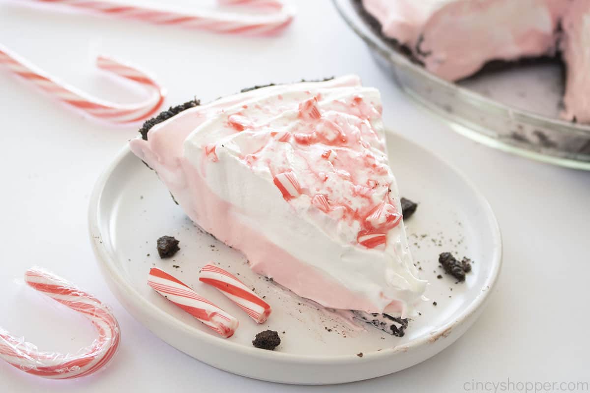 Slice of candy cane cream pie on a plate.