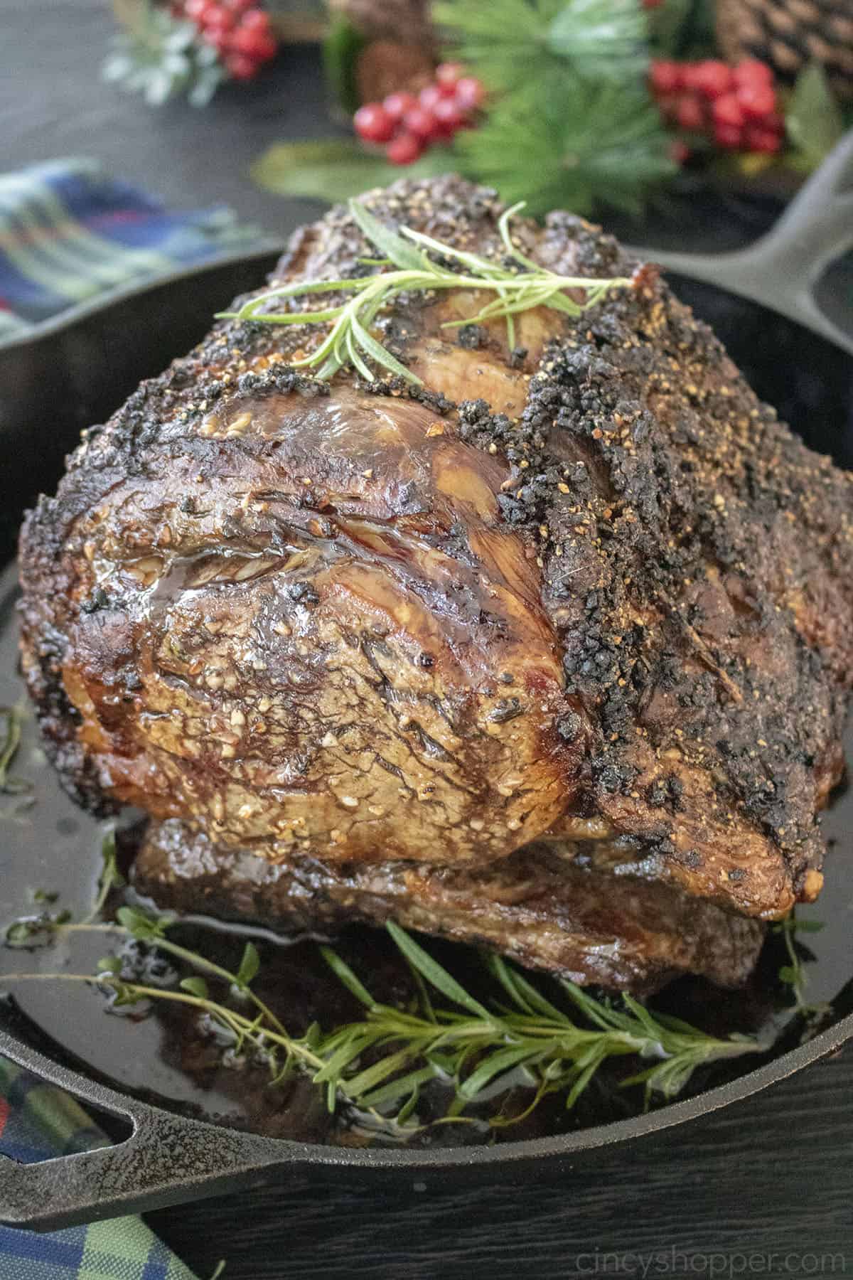 Herb Crusted Prime Rib in a cast iron skillet.