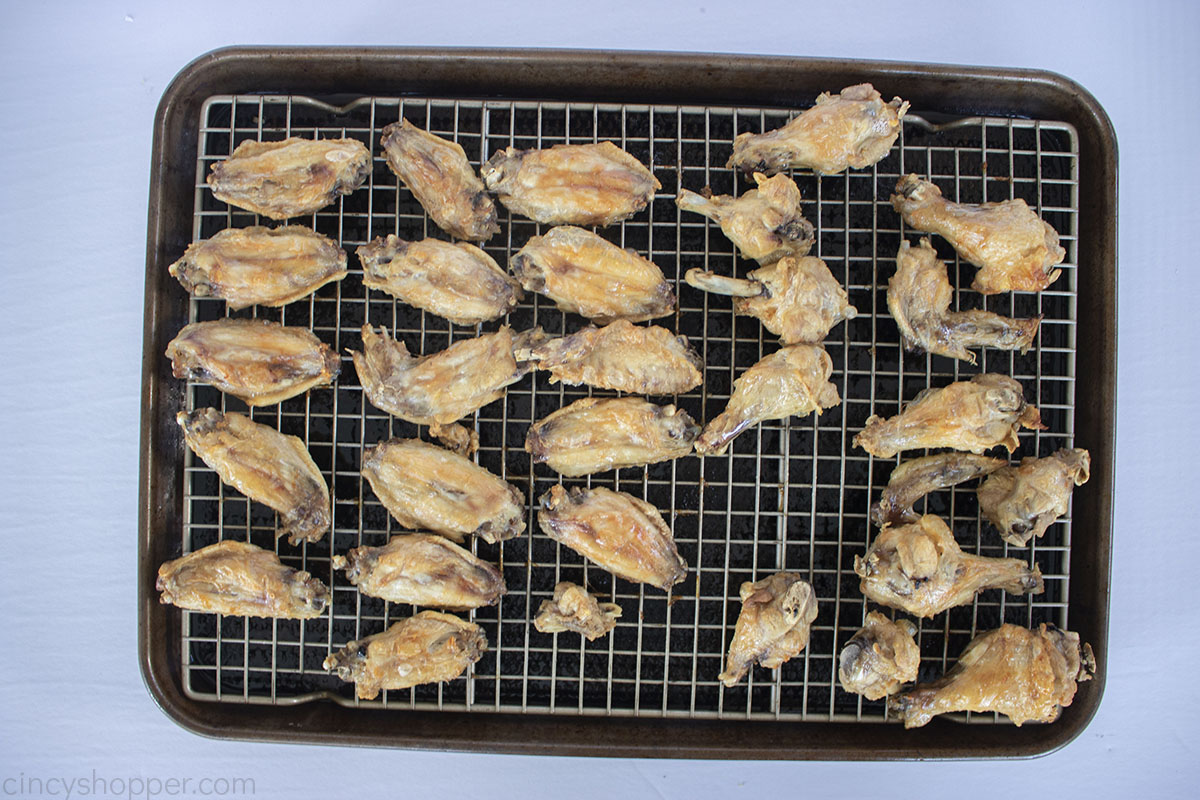 Boiled and baked chicken wings on a sheet pan from oven.