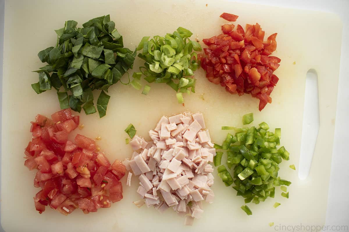 Diced veggies and ham for egg muffins.