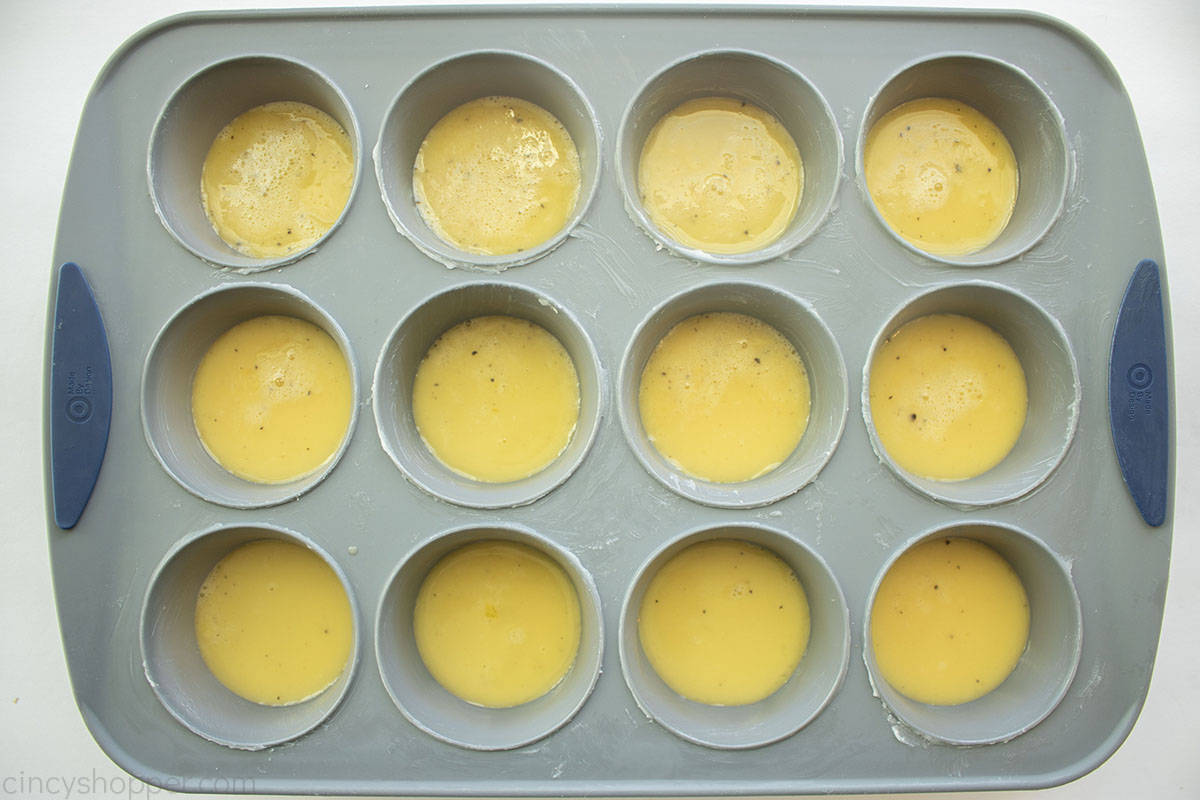 Eggs added to muffin pan.