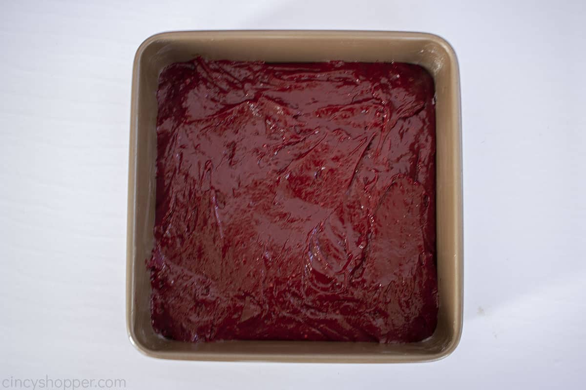 Red Velvet brownie batter in a square baking pan.