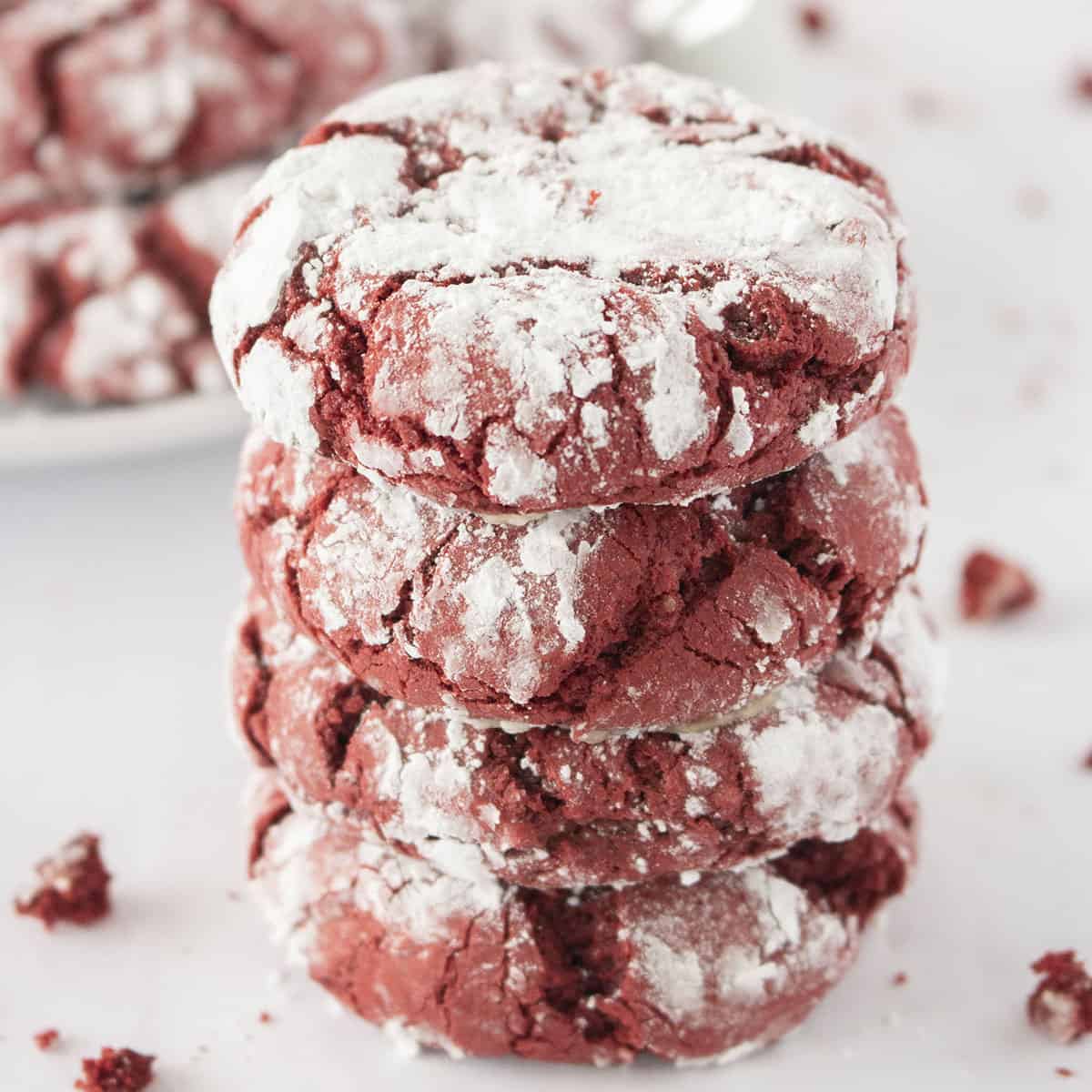 Stack of Red Velvet Crinkle Cookies with crumbs.
