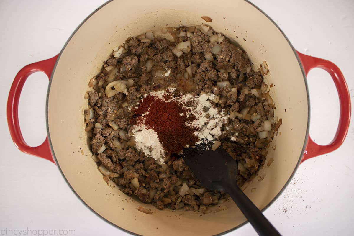 Spices added to ground beef mixture for stew.