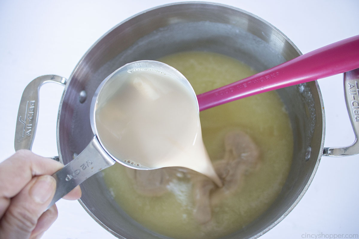 Adding Baileys Irish Cream to glaze in a pan.
