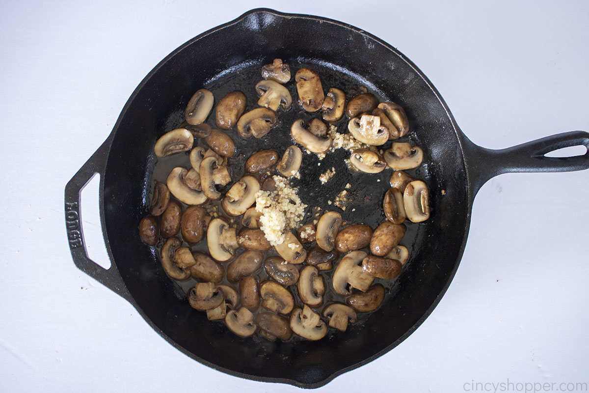 Garlic added to fried mushrooms.