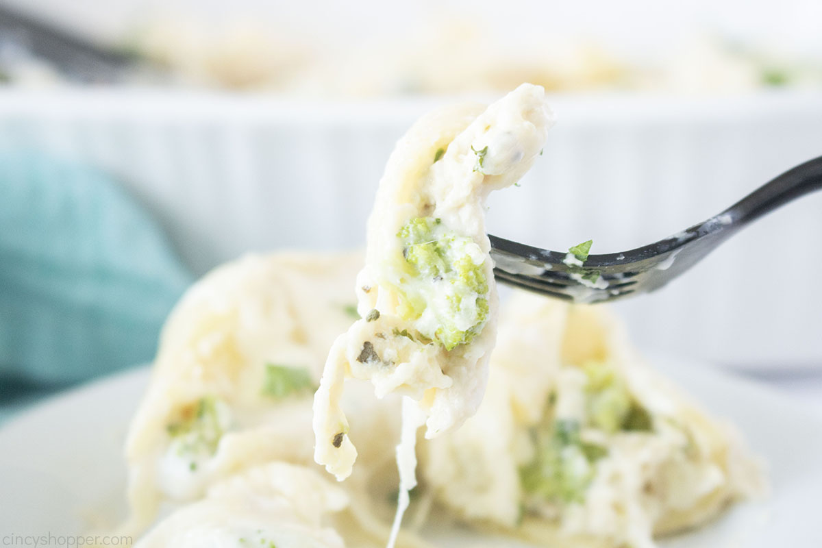 Chicken and broccoli stuffed shells on a fork.