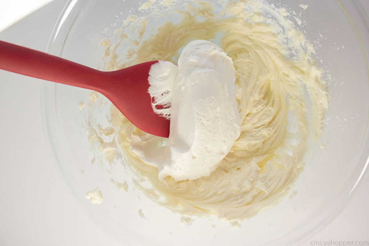 Cool Whip added to the cream cheese mixture with a spatula.