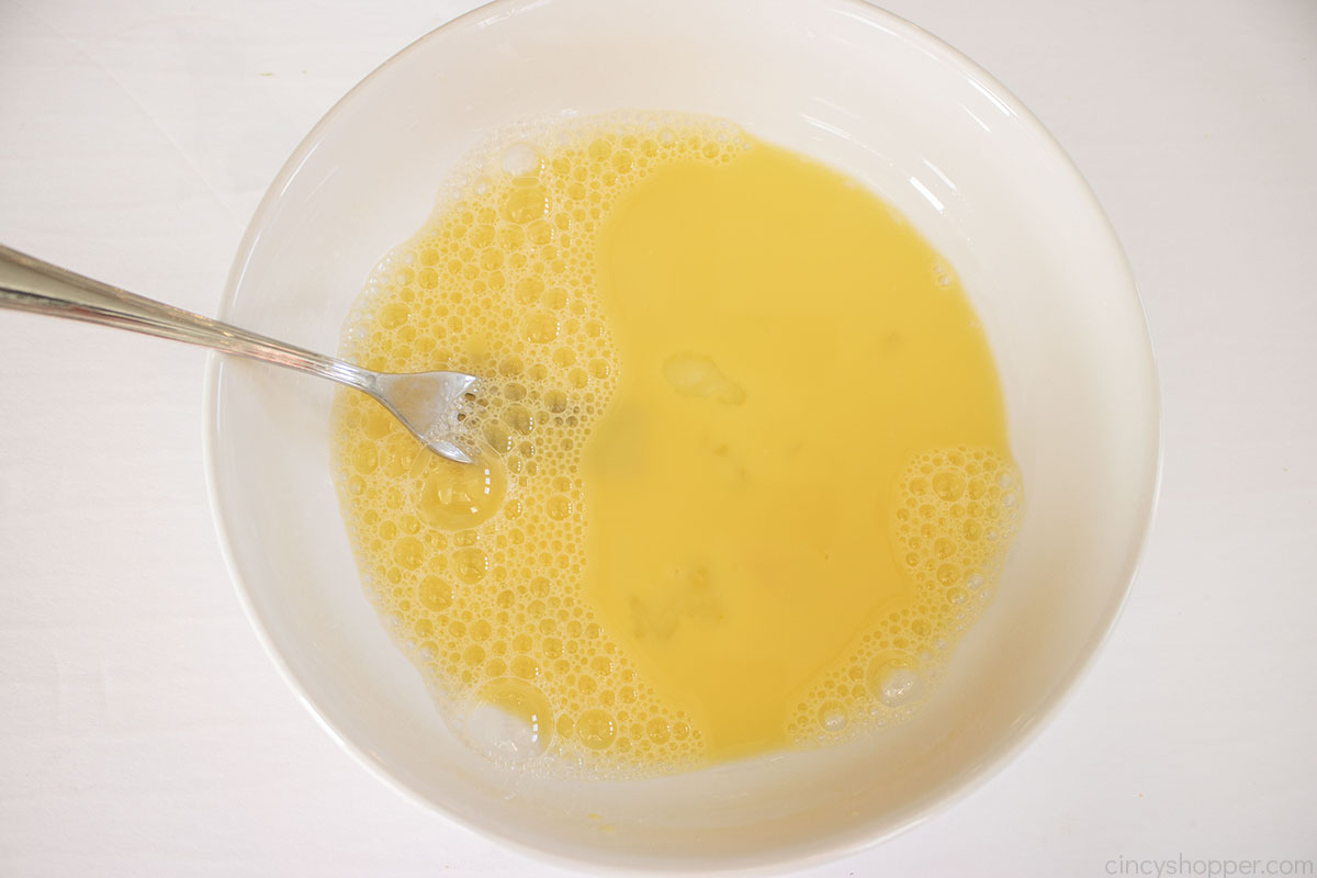 Egg wash in a white bowl