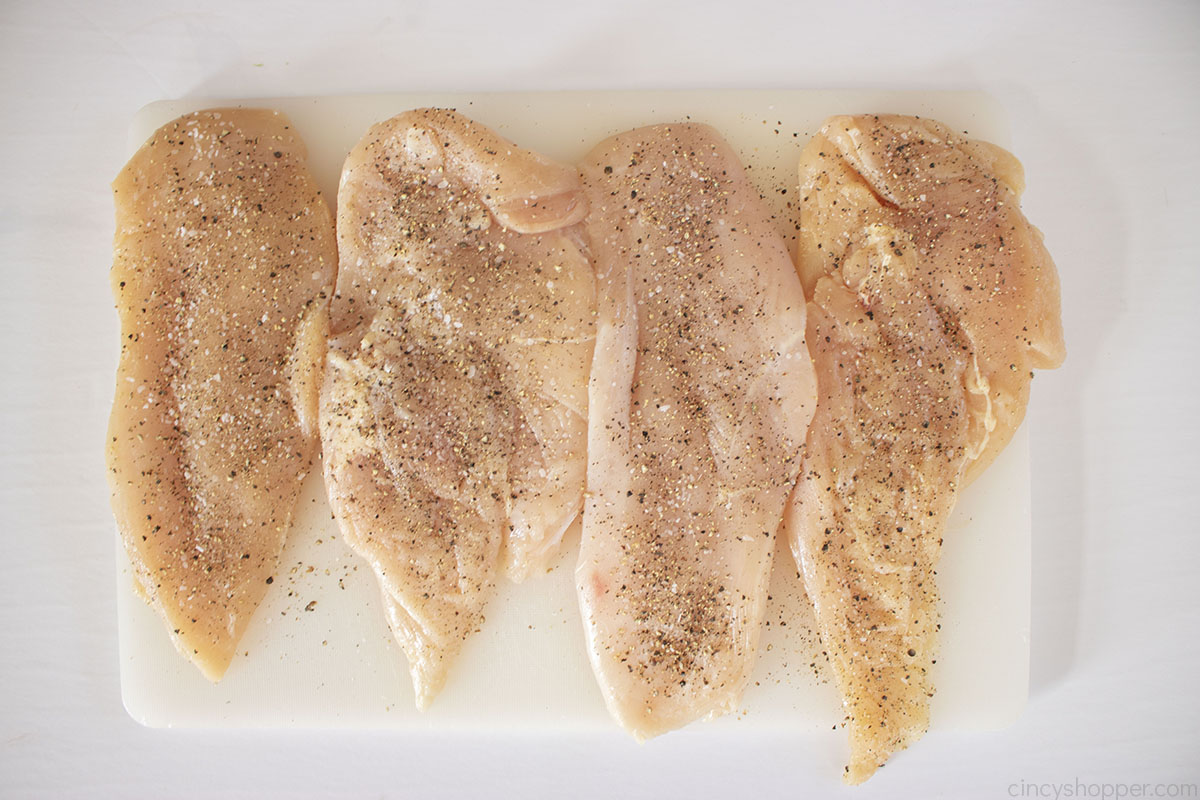 Chicken breasts raw with salt and pepper.
