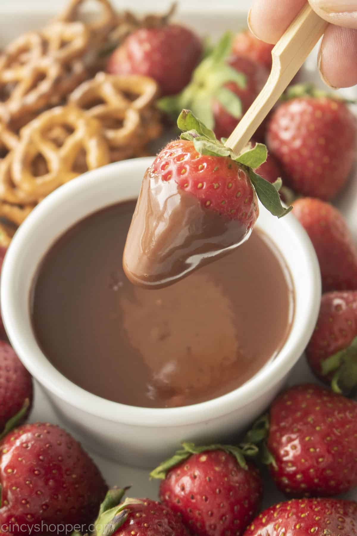 Chocolate dipping sauce on a strawberry.