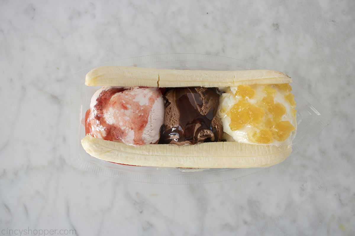 Banana added to topped ice cream.