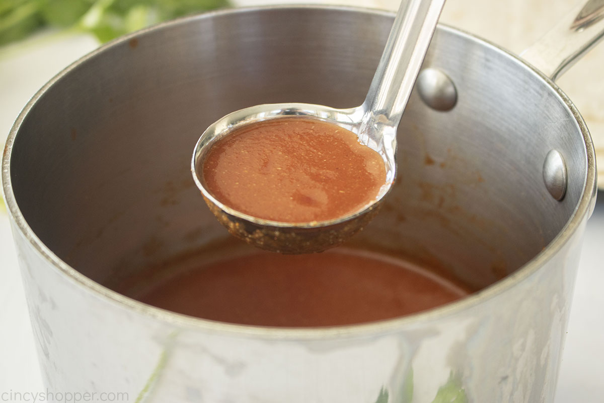 Mexican Red Sauce in a ladle.
