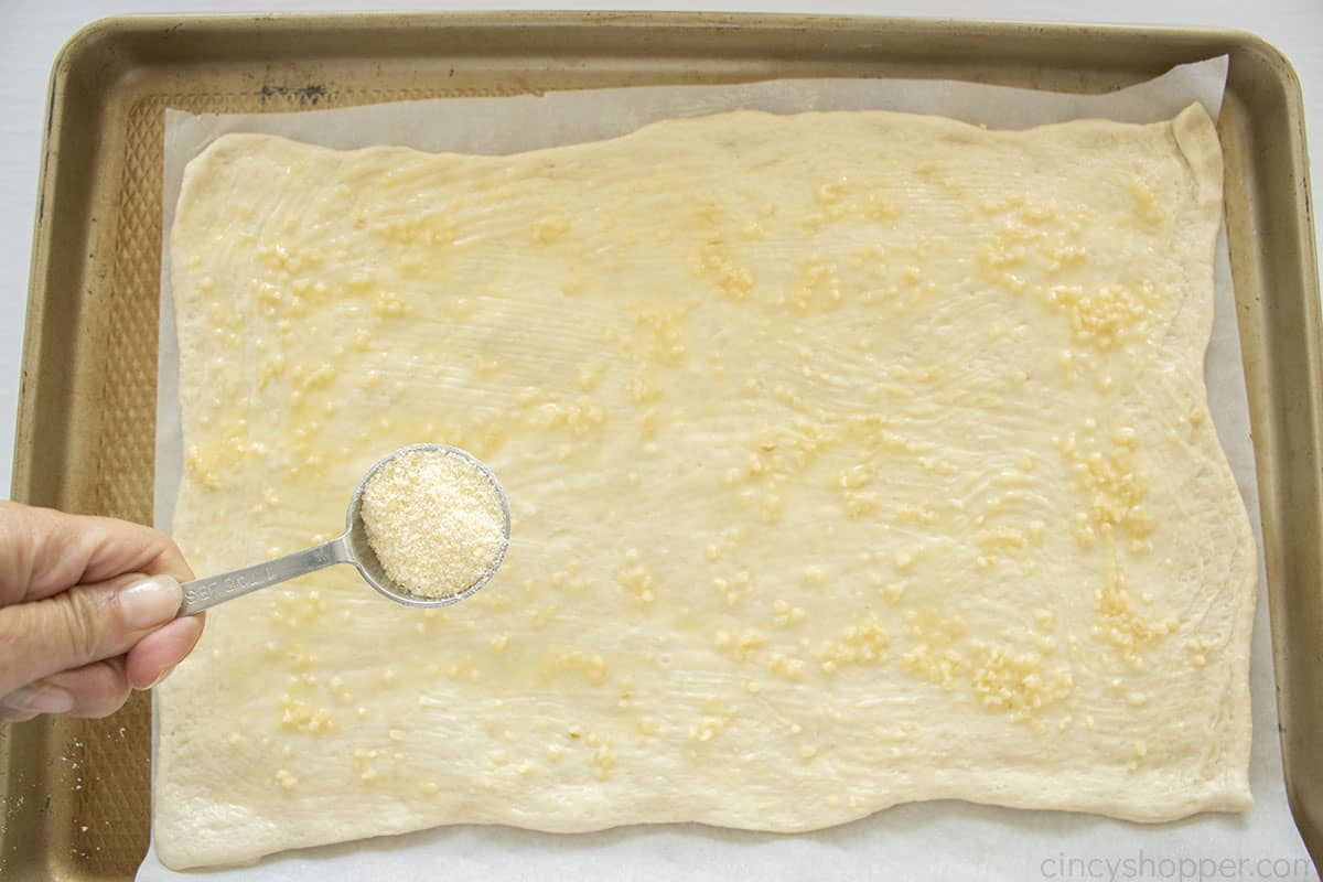 Parmesan cheese added to pizza dough