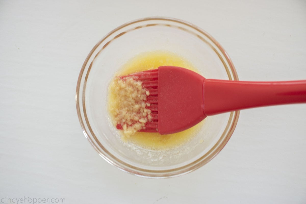 Melted butter with garlic in a bowl.