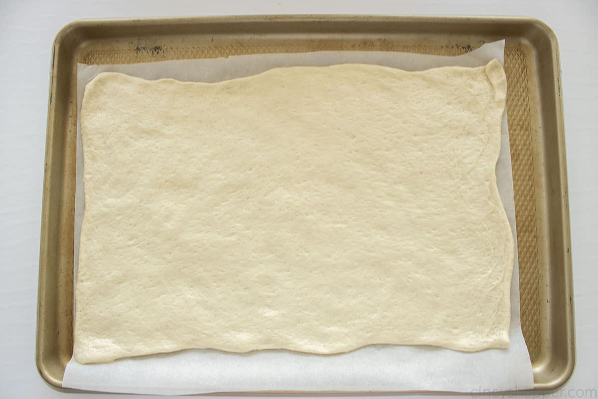 Pizza Crust on top of parchment paper 