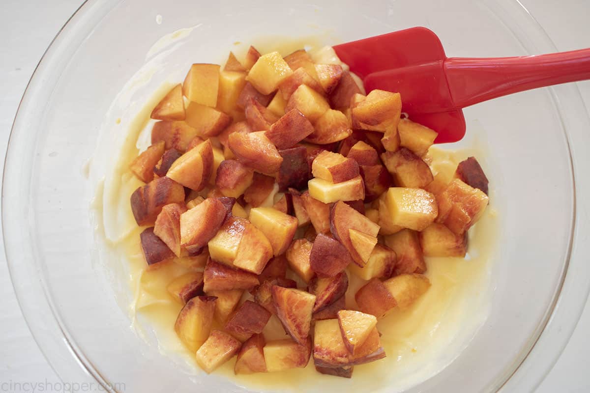 Diced peaches added to peach cheesecake filling mixture.