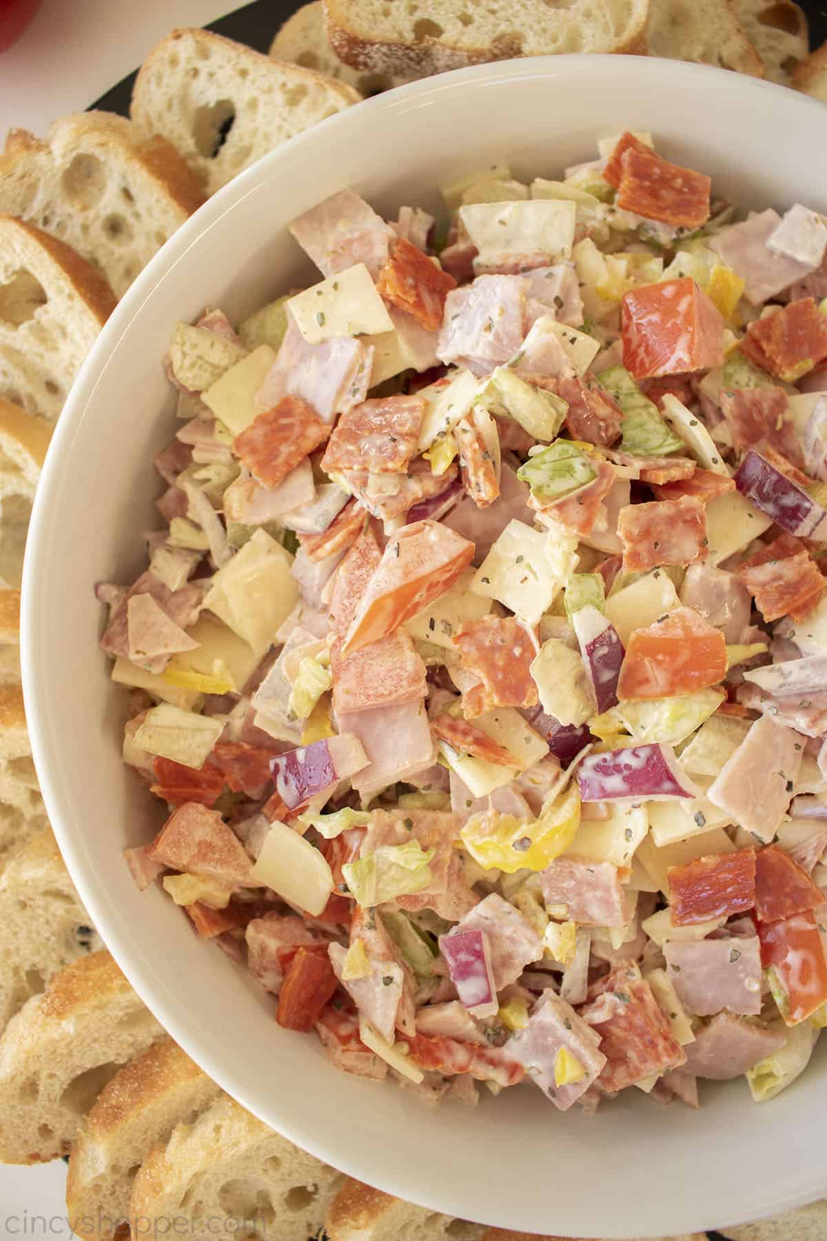 Hoagie Dip in a white bowl with sliced bread.