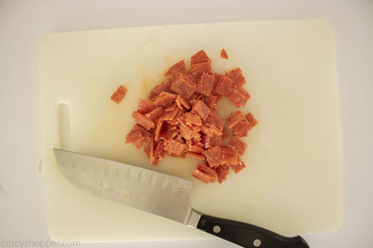 Sliced pepperoni on a cutting board.