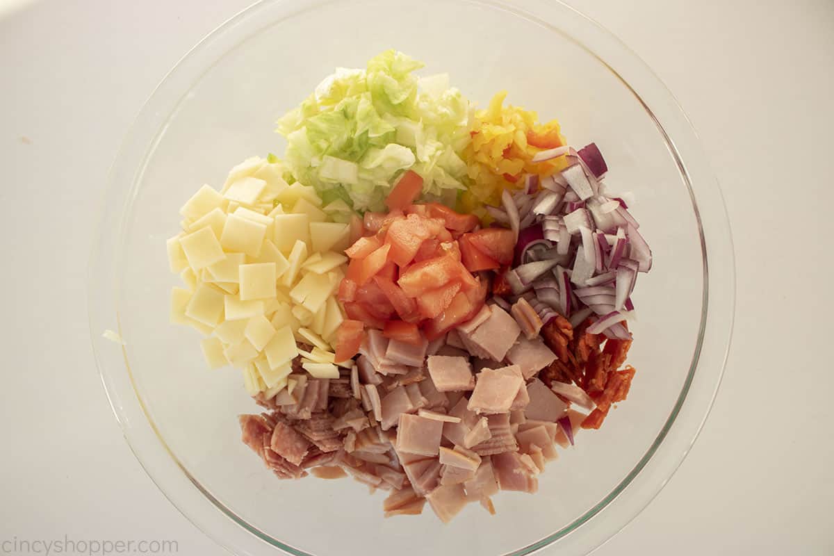 Chopped Hoagie Dip ingredients in a clear bowl.