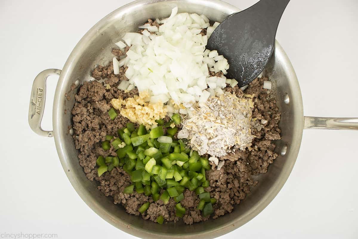 Onions, peppers, garlic, onion soup mix added to browned ground beef.