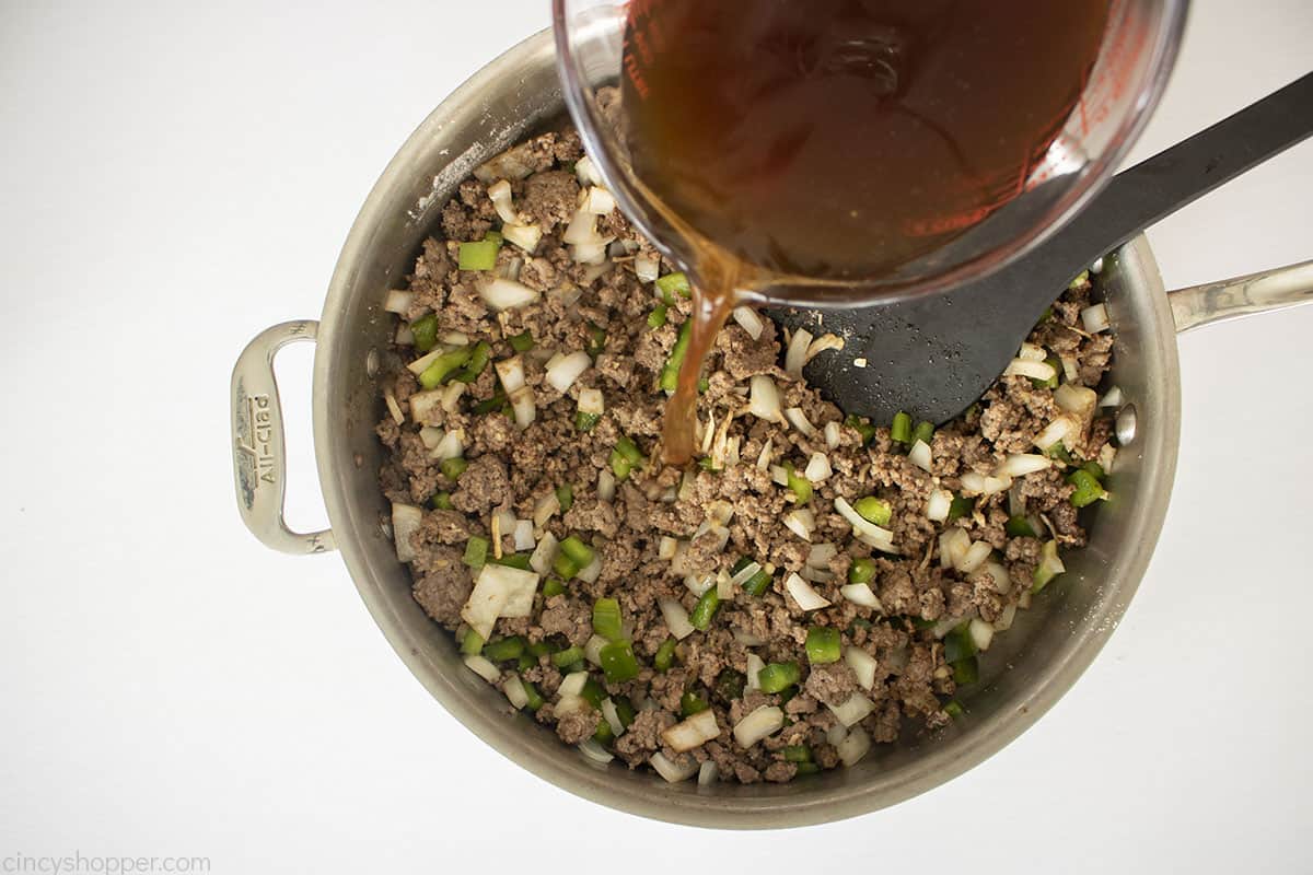 Beef broth added to pan of ground beef mixture.