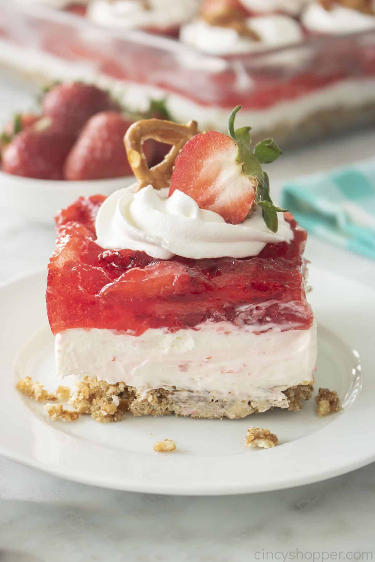 Piece of Strawberry Pretzel Salad on a white Plate.