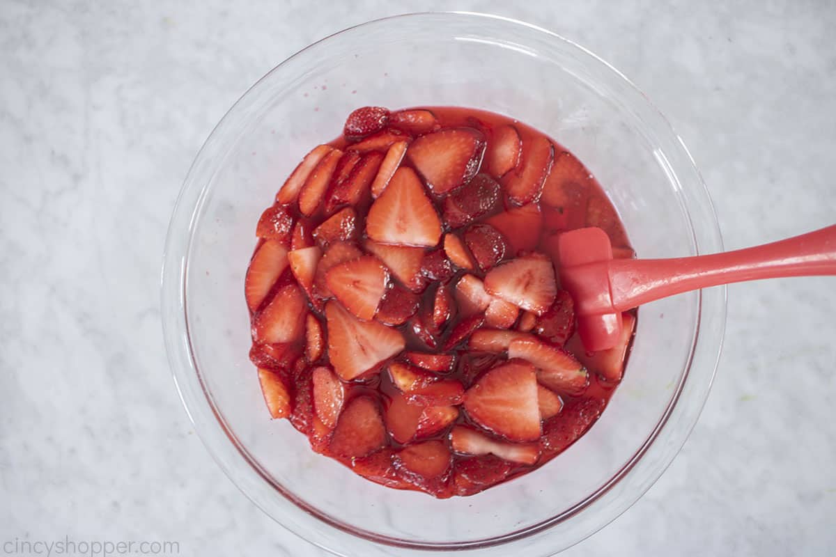 Strawberries added to cooled Jello.