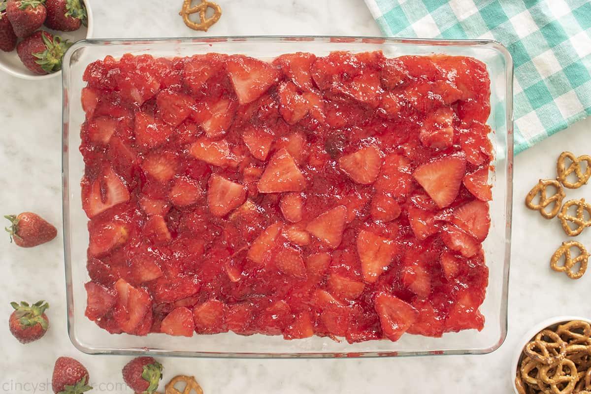 Jello Pretzel Salad with strawberries on top.