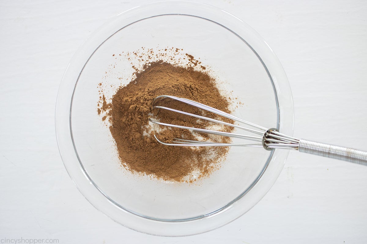 Sugar and cinnamon in a bowl with whisk.