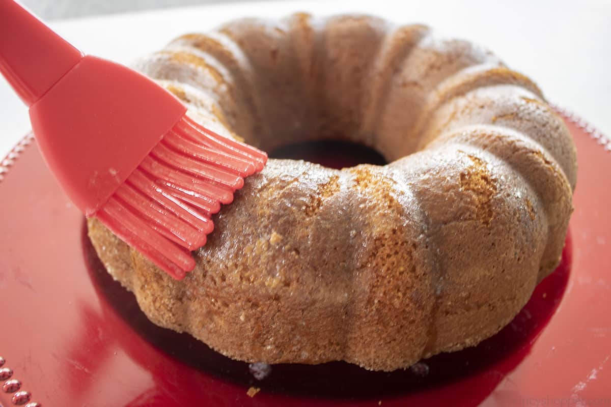 Brushing butter on the top of cake.