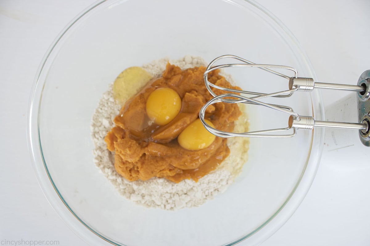 Cake Mix, eggs and pumpkin puree in a mixing bowl with electric mixer.