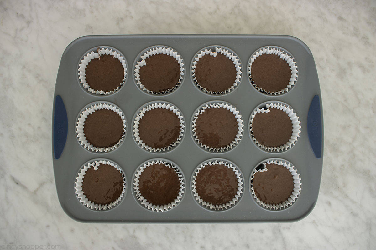 Chocolate cupcake batter in cupcake liners and pan.