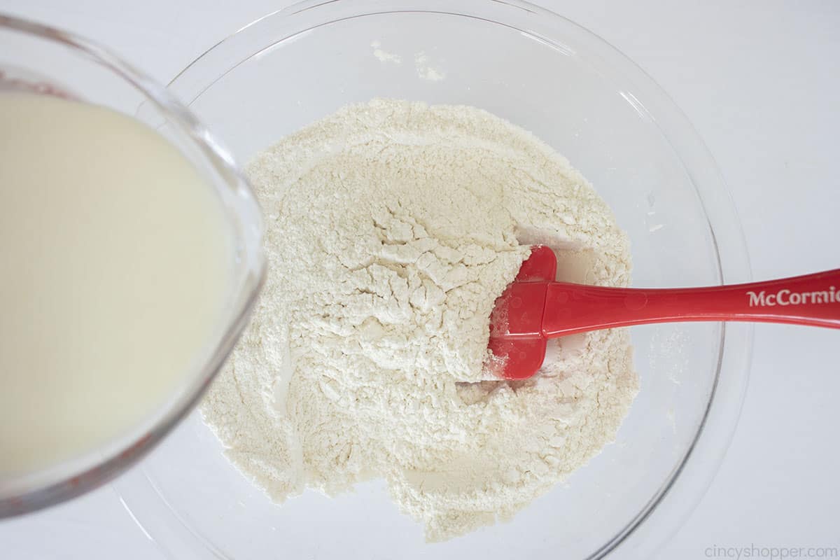 Buttermilk added to dry biscuit ingredients.