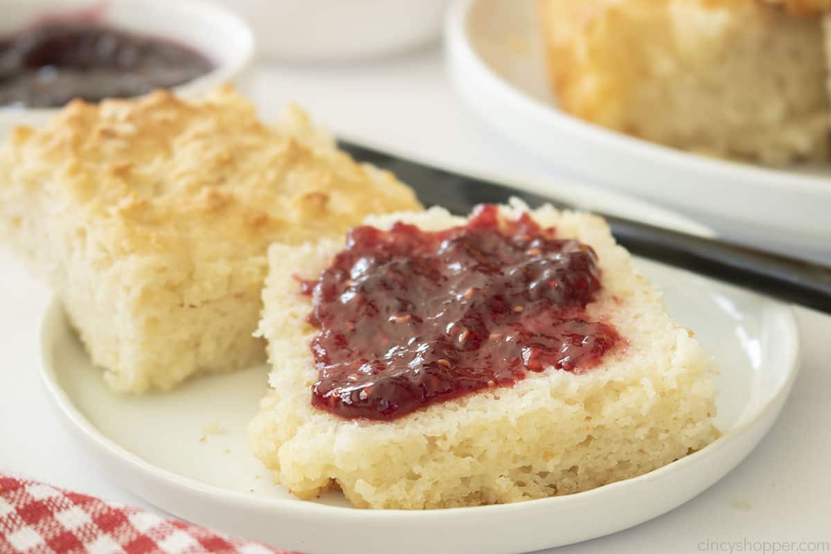 Jam topped Buttermilk Swim Biscuit on a plate.