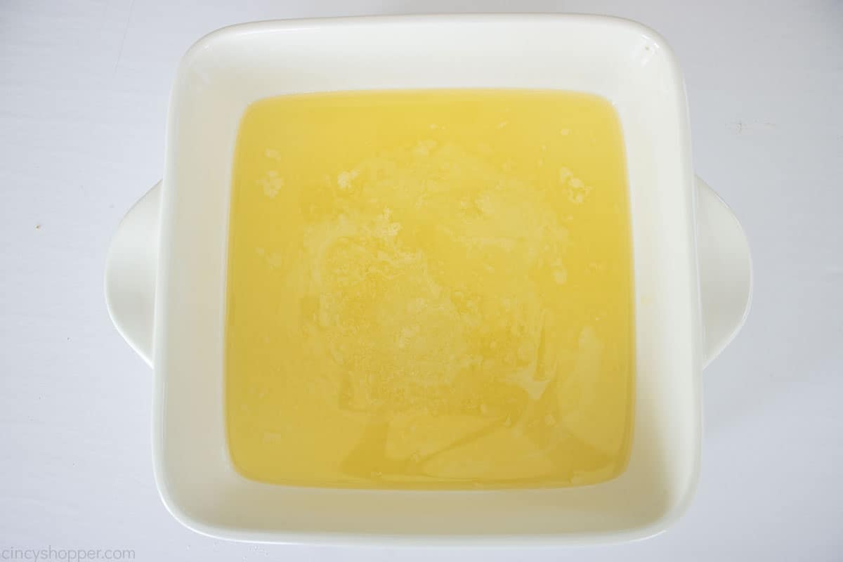 Melted butter in a white baking dish.