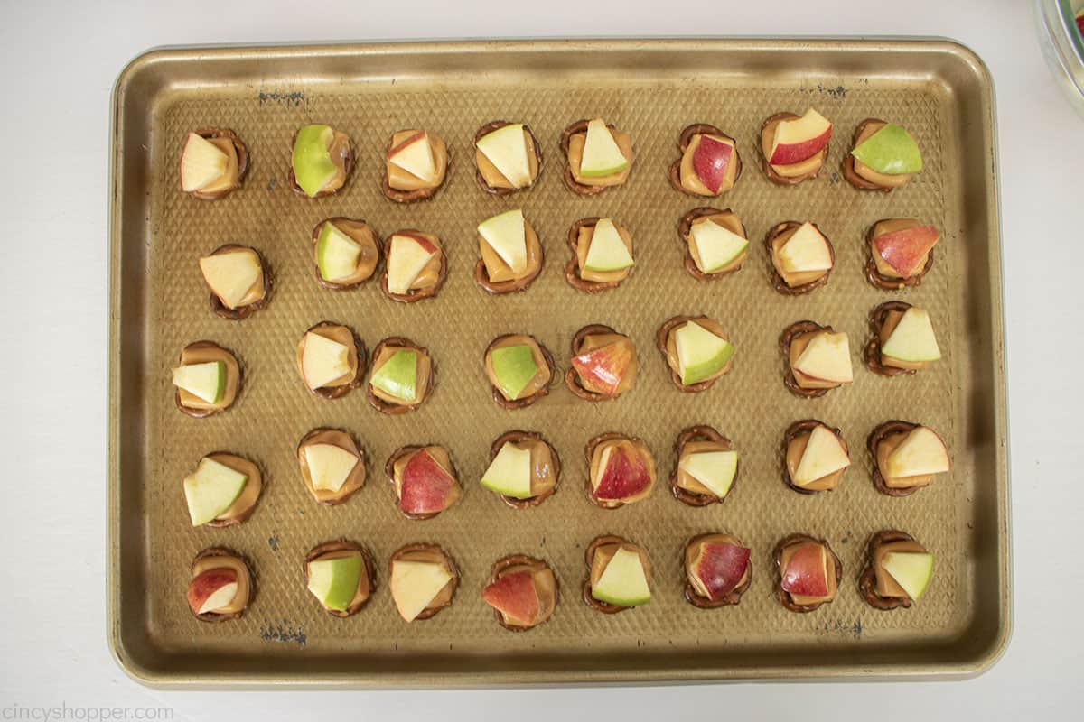 Apples added to the tops of the melted caramel pretzels.