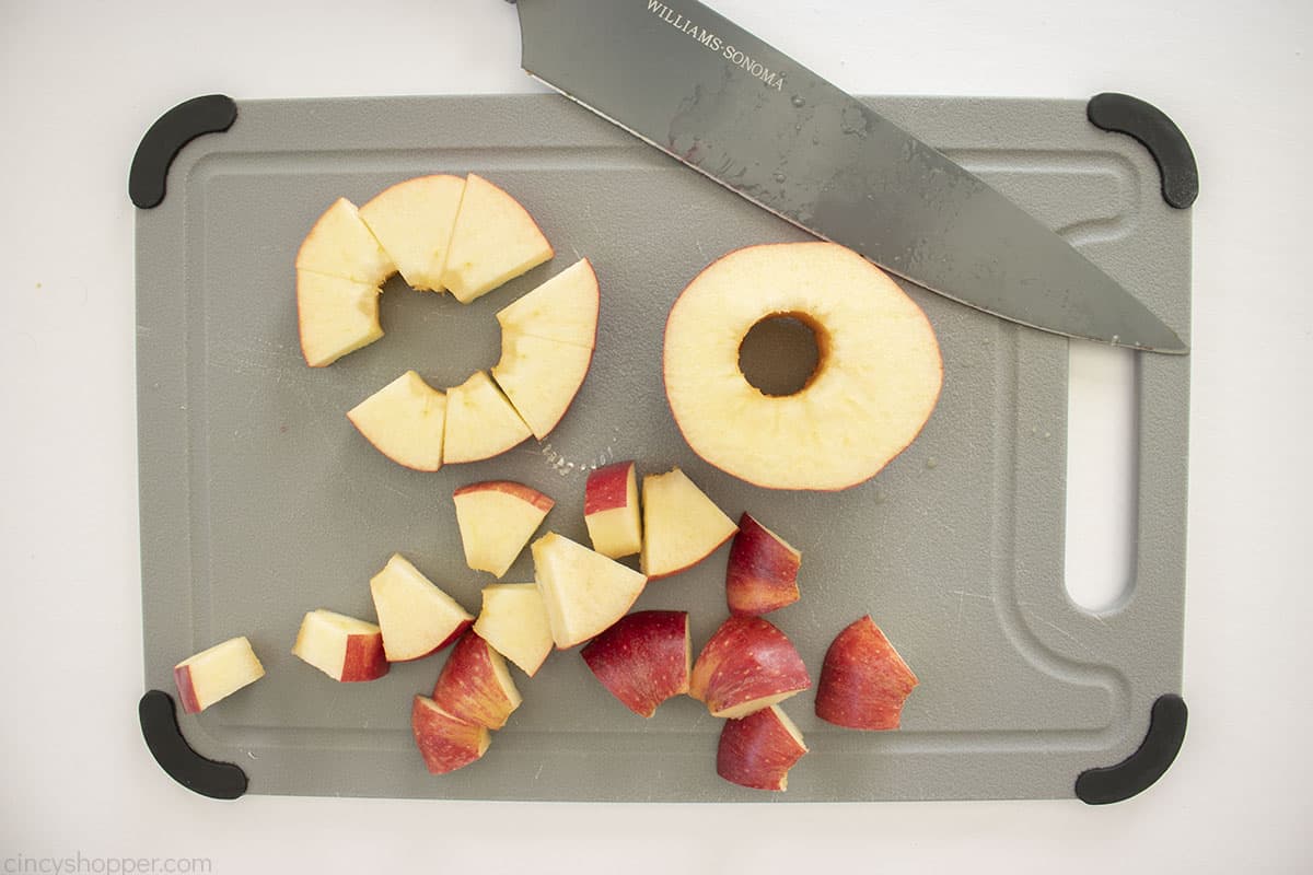 Cored and diced apples on a cutting board.