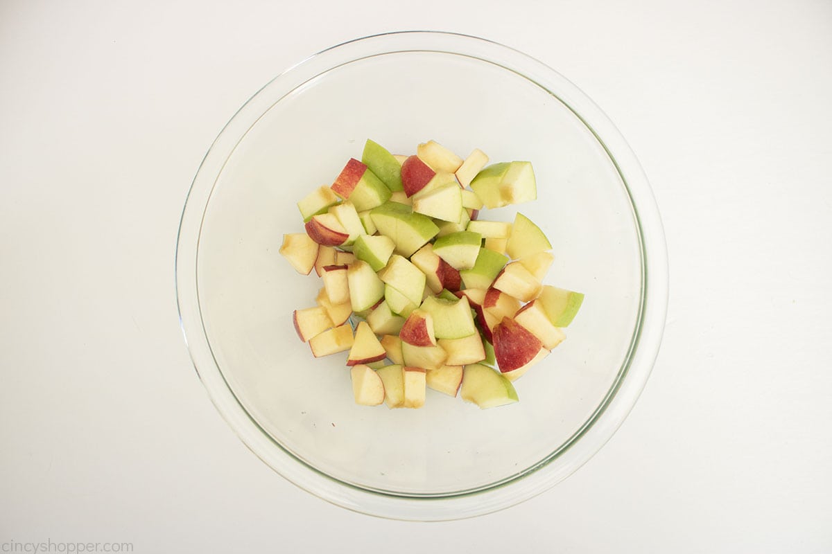 Diced apples in a clear bowl with lemon juice.