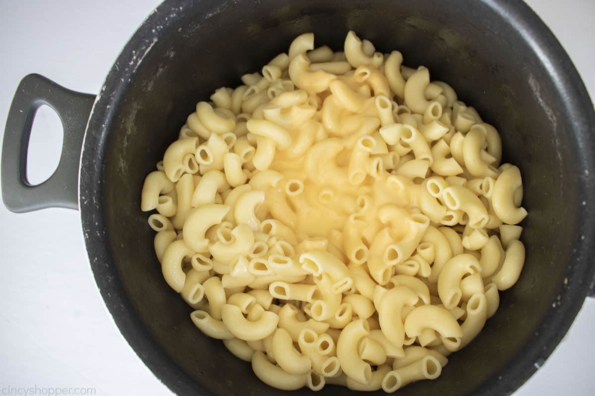 Cheese sauce mixture added to cooked elbow macaroni.