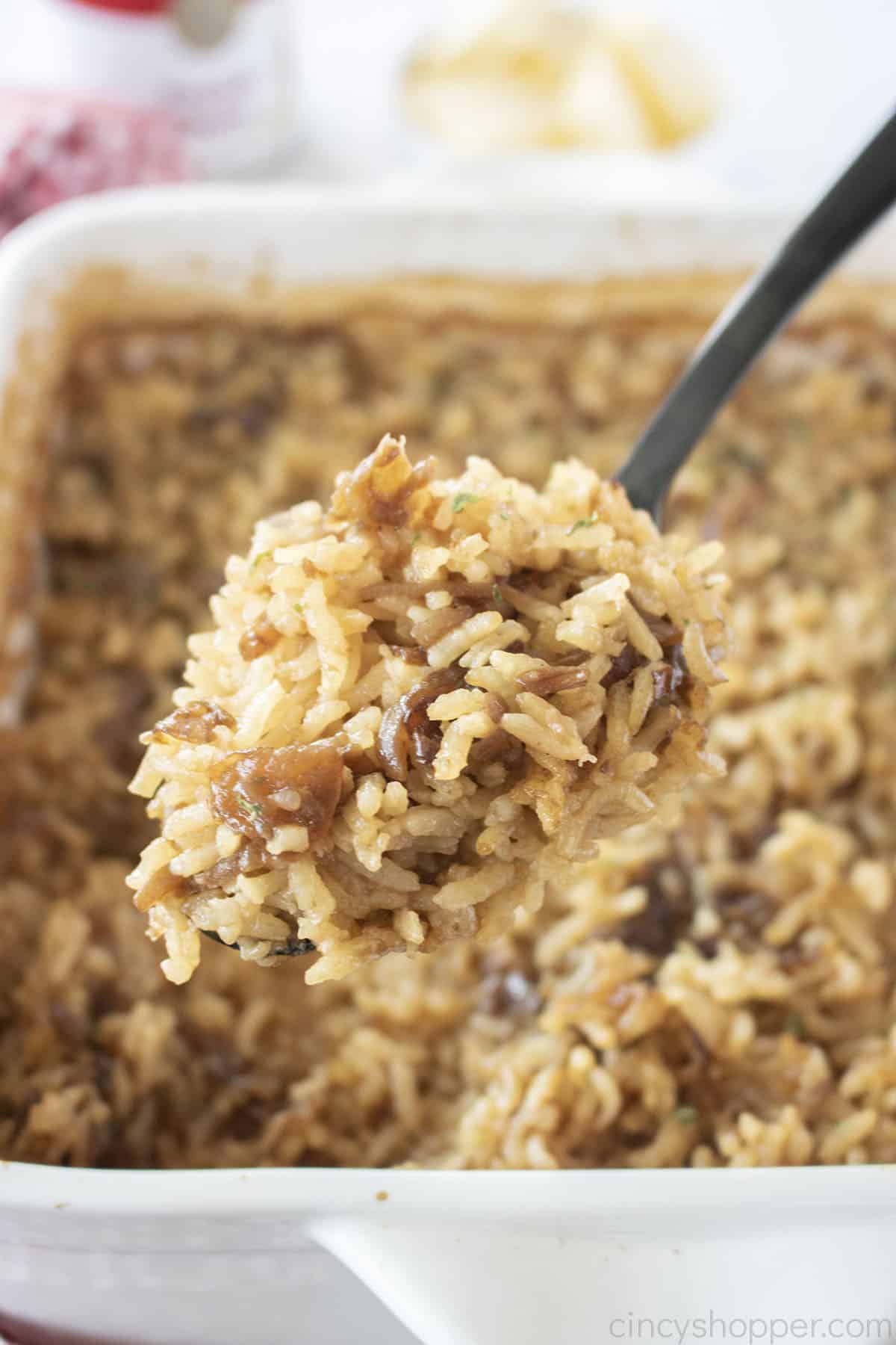 French Onion Soup rice on a black spoon.