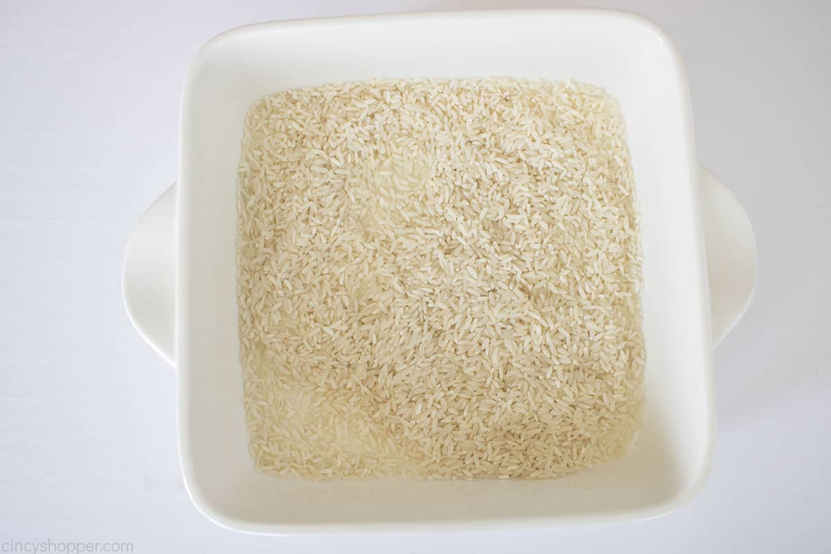 Rice added to white casserole dish.