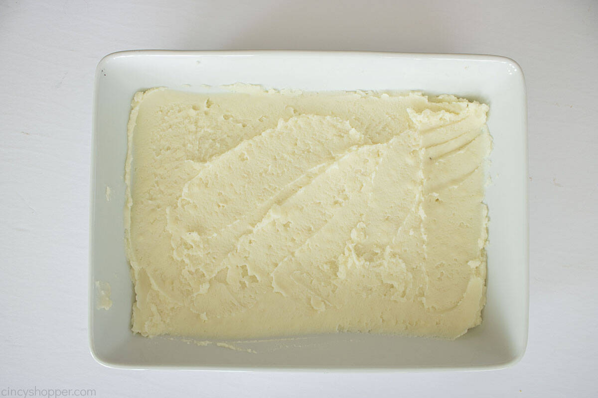 Mashed potatoes layered in a white casserole dish.