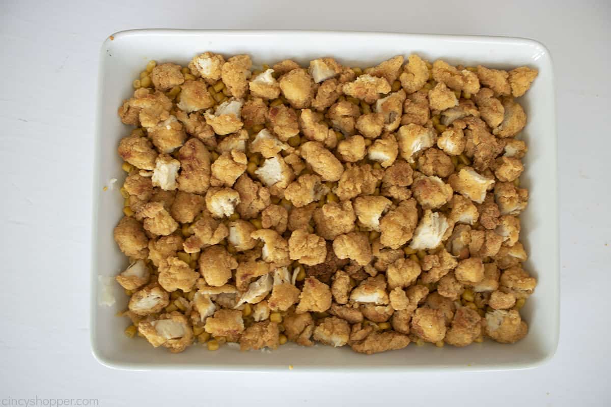 Popcorn chicken layered in casserole dish.