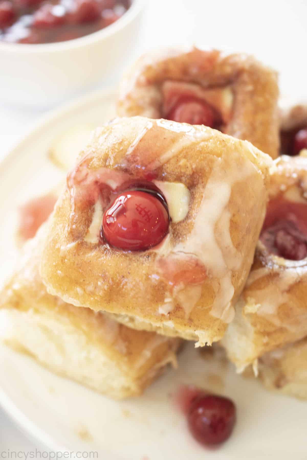 King's Hawaiian Cheese Danish stack on a plate with cherries.